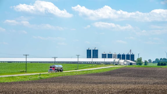 Dairy farm and crop with hauling truck and silos