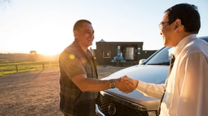 farmer shaking hands with a business person