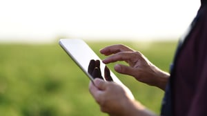 Farmer on tablet in field